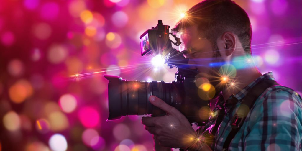 Videographer capturing dynamic footage with professional camera.